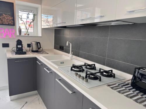 a kitchen with a stove top oven next to a counter at RaRoom Supernova in Torre del Greco