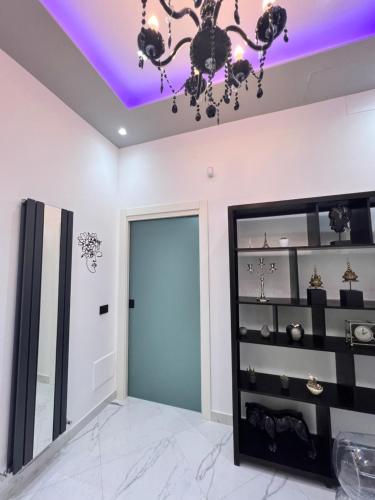a room with a chandelier and a door at RaRoom Supernova in Torre del Greco