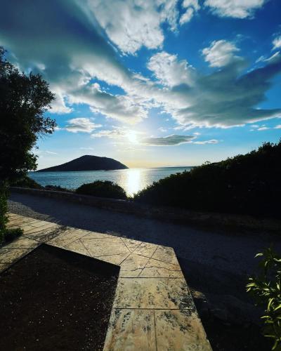 a view of the ocean from a stone walkway at Thedreamlifehouse in Anavissos