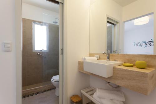 a bathroom with a sink and a toilet at 20 Hotel in Punta del Este