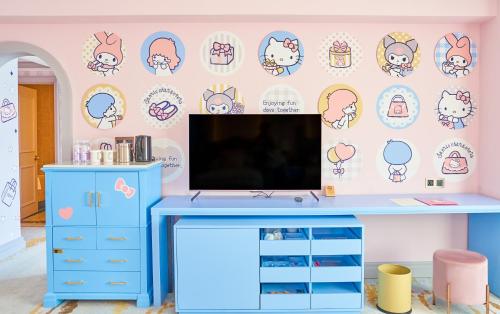 a room with a blue desk and a tv on a wall at Grand Hi Lai Hotel in Kaohsiung
