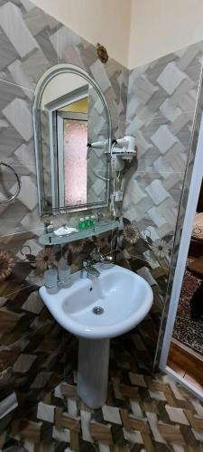 a bathroom with a sink and a mirror at VOSTOK in Samarkand