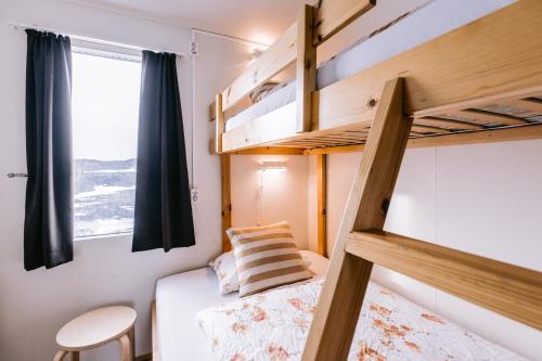 a bedroom with two bunk beds and a window at Hlíd Hostel in Myvatn