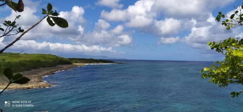 a view of the ocean from the shore of a beach at Kaz a Klemence Gite creole avec piscine et table dhotes a Anse Bertrand in Anse-Bertrand