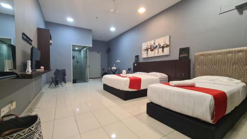 a hotel room with two beds and a bathroom at Aeropod KK Studio Unit 09 Near Airport And City Free Parking in Kota Kinabalu