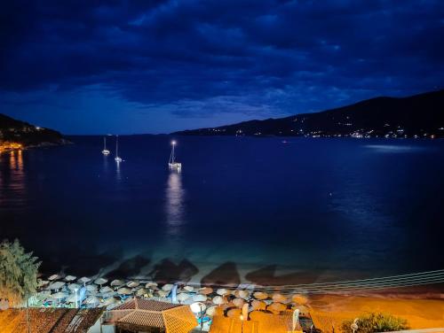 a view of a large body of water at night at New Aegli Resort Hotel in Poros