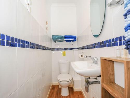 a bathroom with a white toilet and a sink at The Station Masters Lodge in Hayle