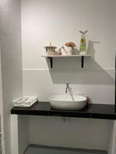 a bathroom counter with a sink and a shelf at Homestay "Feel at Home" Near A Famosa & Jonker Street for 4-7 people in Melaka