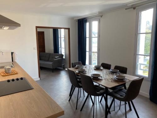 un comedor con mesa y sillas en una habitación en Studio +++ très agréable en centre ville, en Doué-la-Fontaine