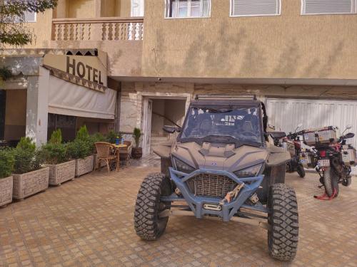 a atv parked in front of a building with a building at Hôtel Imilchil in Midelt