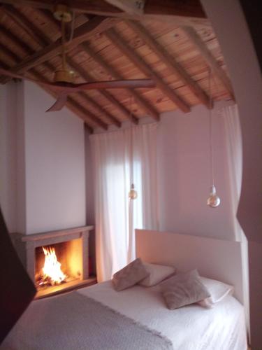a bedroom with a bed and a fire place at Penamacor Cozy Nook House in Penamacor