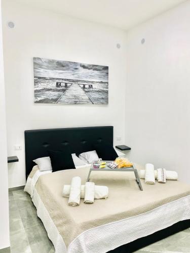 a large bed in a white room with a large bedvisor at Toledo Home in Naples