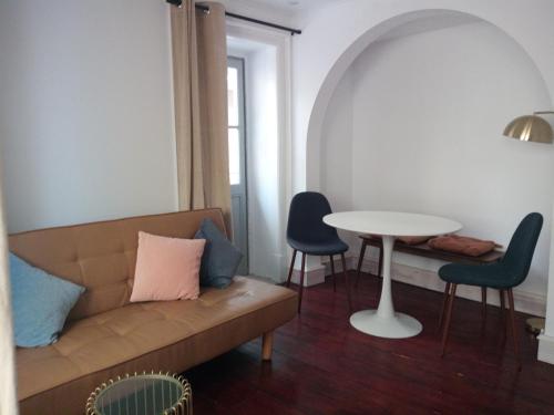 a living room with a couch and a table at Penamacor Cozy Nook House in Penamacor