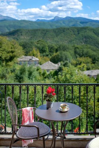 a table and chairs on a balcony with a view at Vera Inn in Dilofo