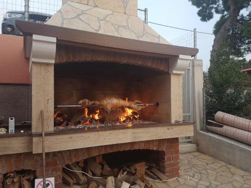 a brick oven with a fire inside of it at EVA in Gornji Karin