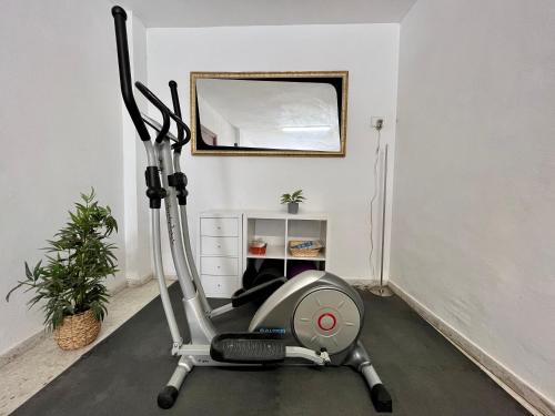 a gym room with a treadmill and a mirror at Casa Valle del Turia in Chulilla