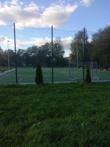 a soccer field with a fence in the grass at Apartament -Jak w domu- Czeladź 60m2 Centrum Katowic 10km in Czeladź