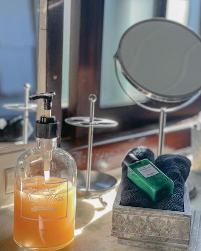 a bottle of soap and a candle on a table at Villa Balthazar in Búzios