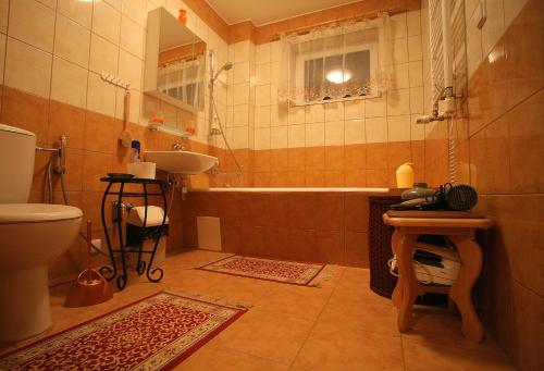 La salle de bains est pourvue d'une baignoire, d'un lavabo et de toilettes. dans l'établissement Neravu namai, à Druskininkai