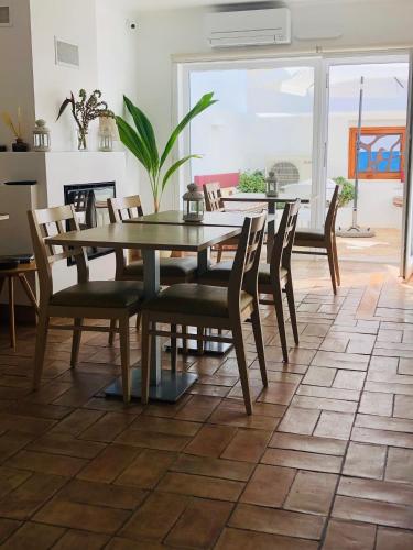 a dining room with a table and chairs at Guarda Rios in Vila Nova de Milfontes