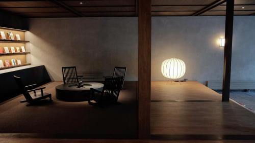 a room with two chairs and a table and a orb at Kobayashiya -Kinosaki Onsen- in Toyooka