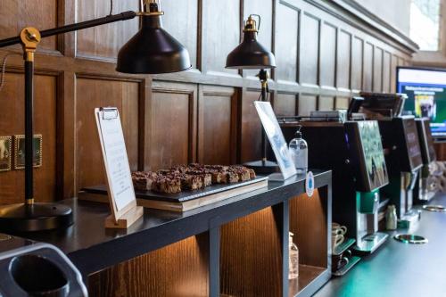 a counter with muffins on a table in a restaurant at Ashorne Hill Leamington Spa in Leamington Spa