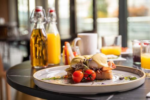 a plate of food on a table with orange juice at Crowne Plaza Budapest by IHG in Budapest