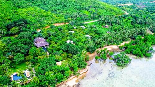 an aerial view of a house on a island next to the ocean at The Dream Beach Resort in Taytay