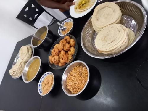 a table topped with plates of food and bowls of dips at Blue Diamond Resort in Trincomalee