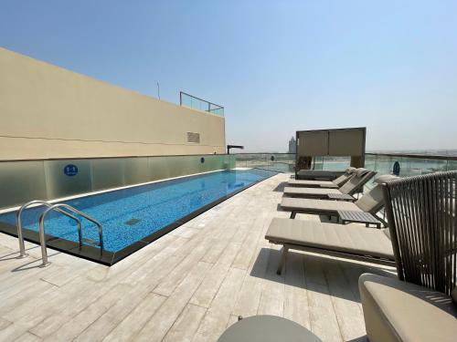 a swimming pool on the top of a building at Citadines Culture Village Dubai, Waterfront Jadaf in Dubai