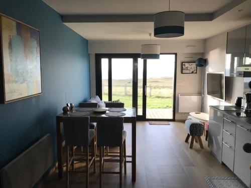 a kitchen and dining room with a table and chairs at charmant studio vue mer in Wimereux