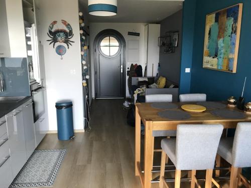 a kitchen and dining room with a table and chairs at charmant studio vue mer in Wimereux