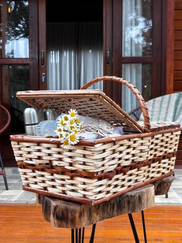 a wicker basket on a stand on a table at Pousada Maçã Araucária in São Joaquim
