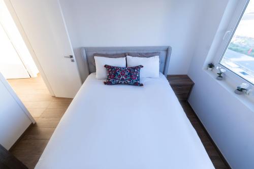 a bed in a small room with a window at Dene Hollow Oroklini in Voroklini