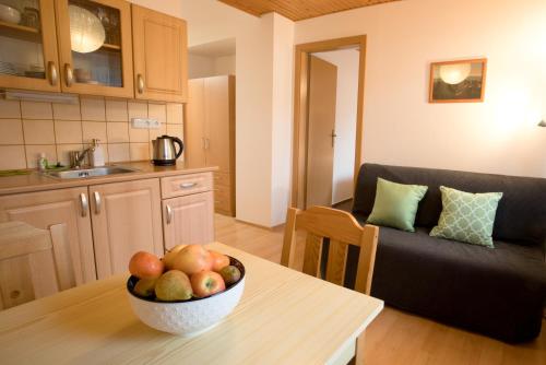 a bowl of fruit on a table in a kitchen at Apartmány Bramborka in Janov nad Nisou