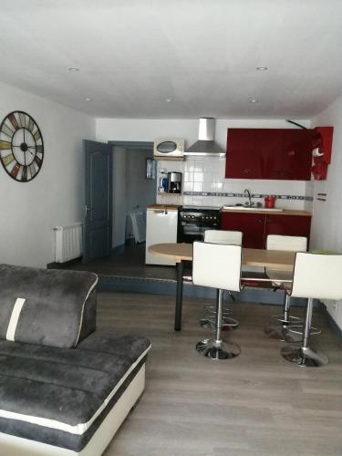 a kitchen and living room with a table and chairs at à 2 pas du centre ville in Parthenay