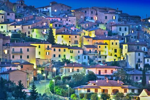 a group of houses on a hill at night at Fortuna Resort in Chianciano Terme