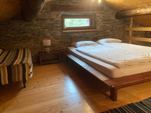 a bedroom with two bunk beds and a window at Rustico a Roveredo GR in Roveredo