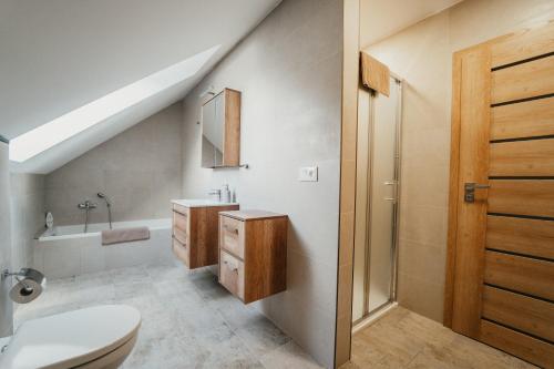 a bathroom with a white toilet and a sink at Apartmán Na Palouku Povrly in Povrly