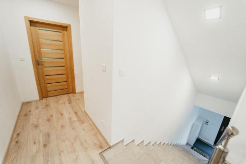 an empty room with a staircase and a door at Apartmán Na Palouku Povrly in Povrly