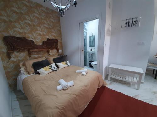 a bedroom with a large bed with two towels on it at Santa Marta in Martos