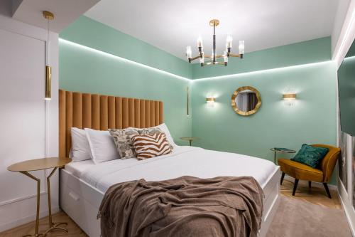 a bedroom with a large bed and a chandelier at HOLT - Leagues and Words Under The Sea in Bucharest