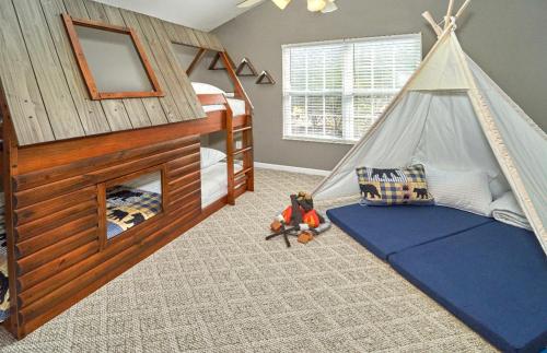 a childs bedroom with a bed and a tent at Log Bunk Bed, Playhouse, & TeePee-Willow Trace Retreat 5mi to Dollywood in Sevierville