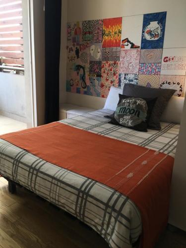 a bedroom with a bed with a wall of stickers at Dormy en Belgrano in Buenos Aires