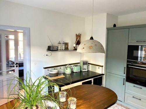 a kitchen with a table and a stove top oven at Villa B das zauberhafte Chalet in Vetschau