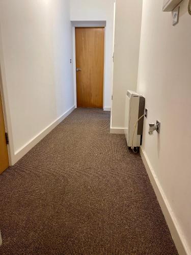um corredor vazio com uma porta e um quarto em Town centre flat in Darlington (free Parking) em Darlington
