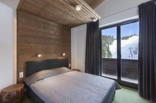 Кровать или кровати в номере Apparthotel Silbersee