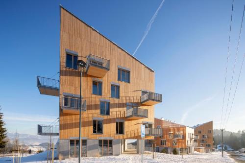 a building with balconies on the side of it at Apartmán Hillside Panorama in Dolný Kubín