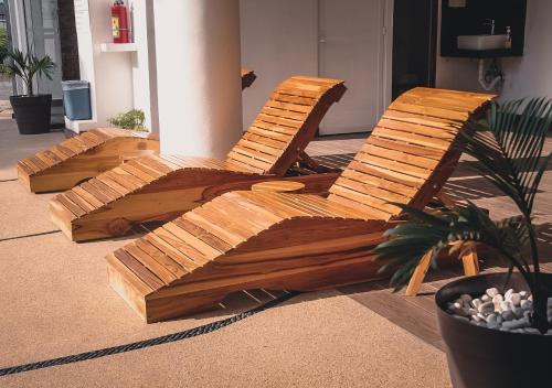 two wooden chairs sitting on the floor of a building at Hubun Hotel Boutique in Los Ayala