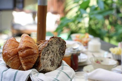 a basket of bread and croissants on a table at Villa Balthazar in Búzios